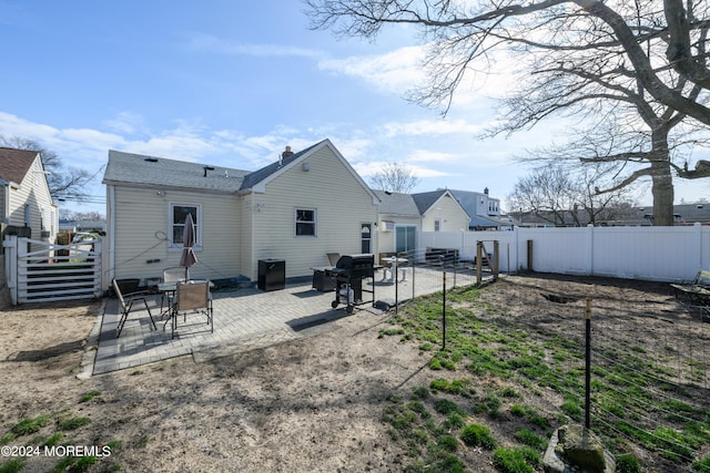 back of property featuring a fenced backyard and a patio