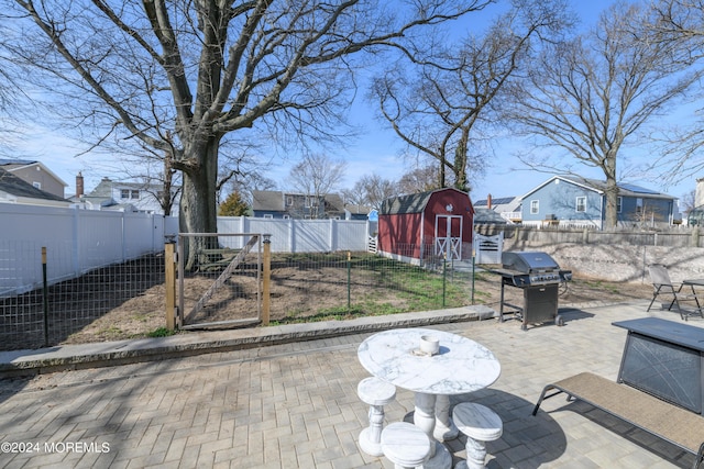 view of yard featuring an outbuilding, a patio area, and a fenced backyard