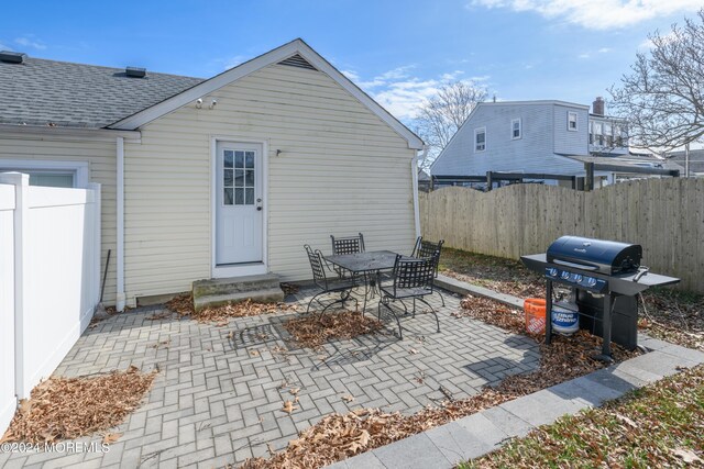 view of patio / terrace featuring entry steps, fence, and grilling area