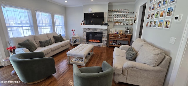 living room with ornamental molding, recessed lighting, dark wood-style flooring, and a fireplace