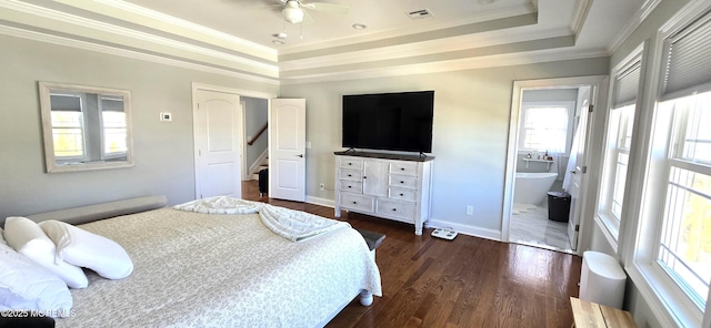 bedroom with dark wood-style flooring, a raised ceiling, visible vents, and crown molding