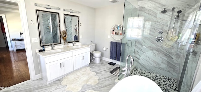 bathroom with a stall shower, marble finish floor, a sink, and toilet