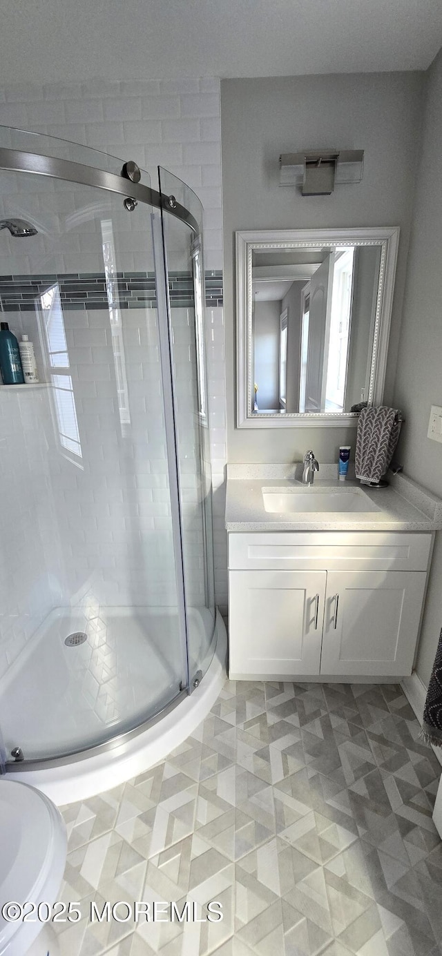 full bath featuring a shower stall and vanity