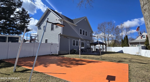 exterior space featuring a fenced backyard, a gazebo, a gate, a yard, and a patio area