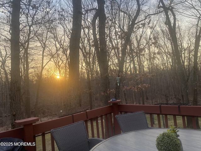 deck at dusk with outdoor dining area