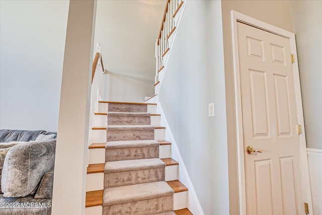 stairway featuring baseboards