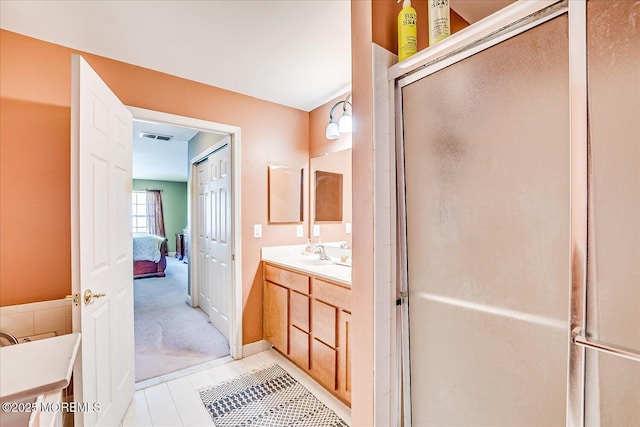 bathroom with visible vents, connected bathroom, a stall shower, and vanity