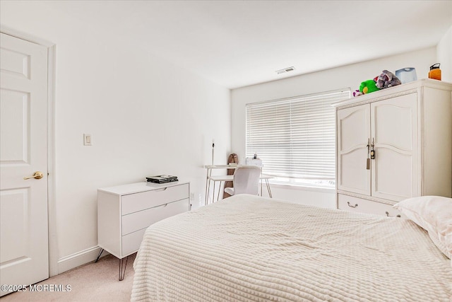 bedroom featuring visible vents and light colored carpet