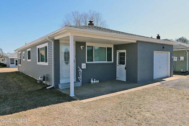 view of front of home featuring a front lawn, brick siding, and a chimney