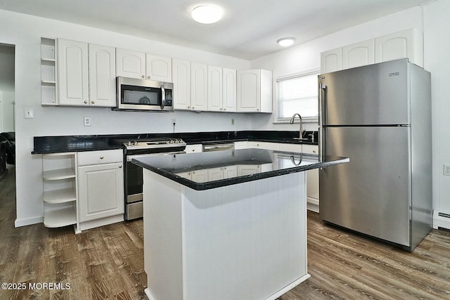 kitchen featuring open shelves, stainless steel appliances, dark countertops, and white cabinetry