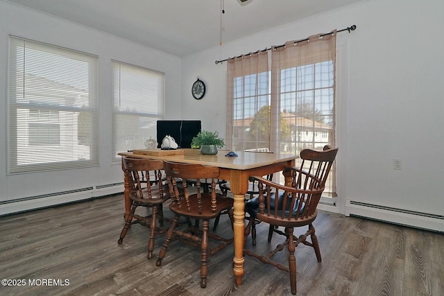 dining room with a baseboard radiator and wood finished floors