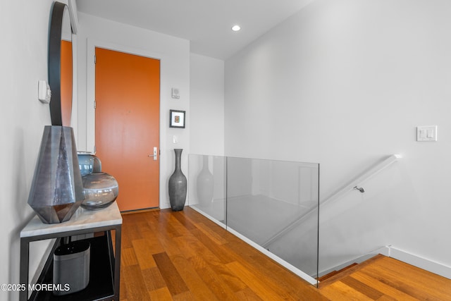 hallway featuring recessed lighting, baseboards, and wood finished floors