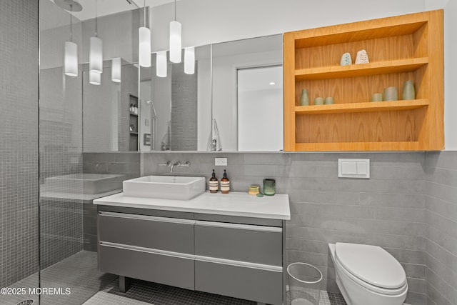 full bath featuring vanity, tile walls, toilet, and walk in shower