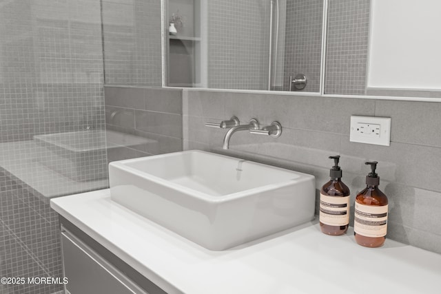 bathroom with a sink and tile walls