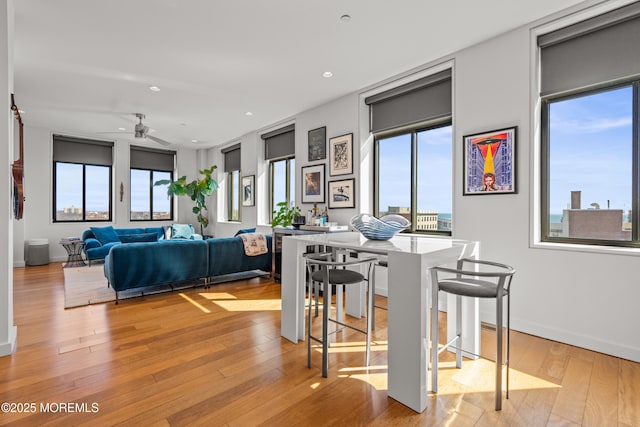 dining room featuring recessed lighting, light wood-type flooring, baseboards, and a ceiling fan