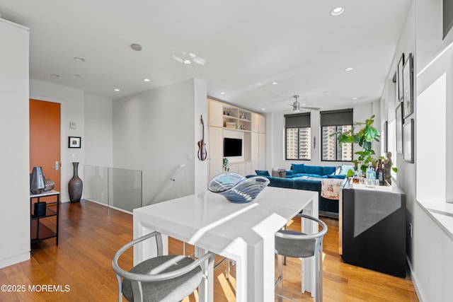 dining space featuring a ceiling fan, recessed lighting, light wood-style floors, and baseboards