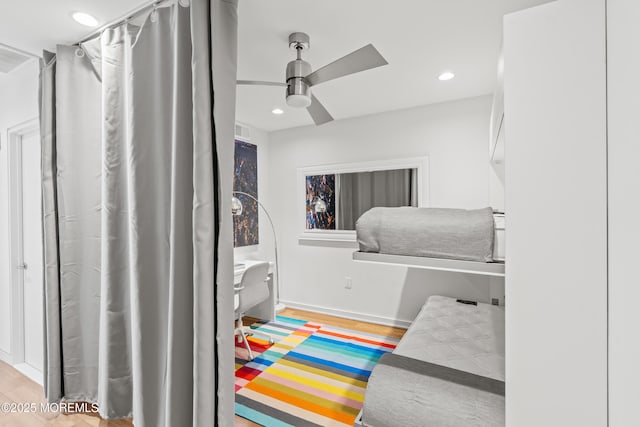 bedroom with recessed lighting, wood finished floors, visible vents, and baseboards