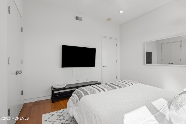 bedroom with visible vents, recessed lighting, and wood finished floors