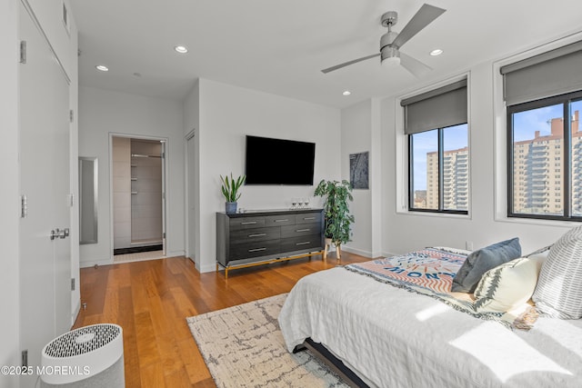 bedroom featuring recessed lighting, baseboards, wood finished floors, and ceiling fan