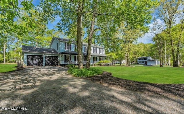 view of front of home featuring driveway, a front yard, and an attached garage