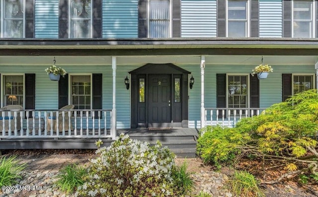 property entrance with covered porch