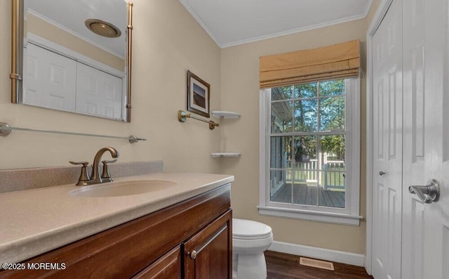 bathroom featuring visible vents, baseboards, toilet, ornamental molding, and vanity