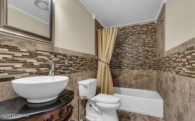 bathroom featuring vanity, shower / bath combination with curtain, wainscoting, tile walls, and toilet