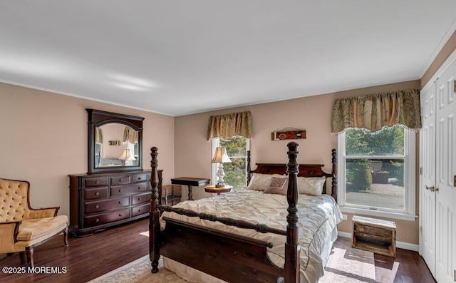 bedroom with baseboards and wood finished floors