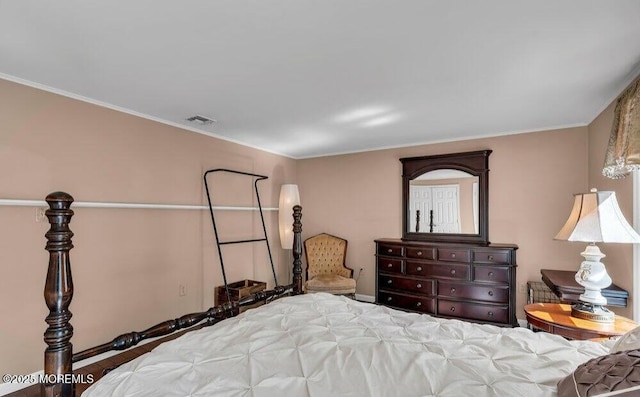 bedroom featuring visible vents and crown molding