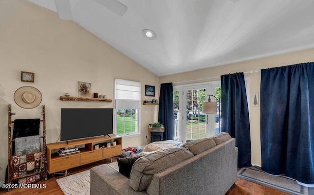 living room with lofted ceiling, recessed lighting, and wood finished floors