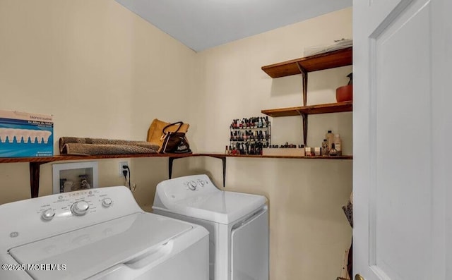 laundry area featuring washer and clothes dryer, laundry area, and a dry bar