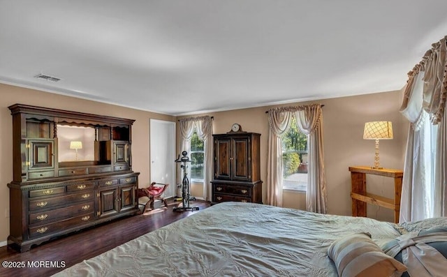 bedroom featuring dark wood finished floors and visible vents