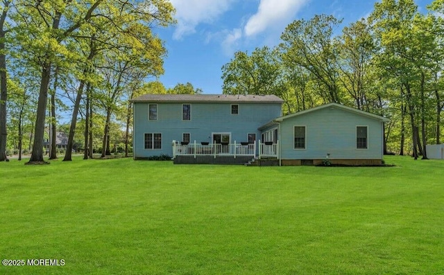 back of house featuring a yard and a deck