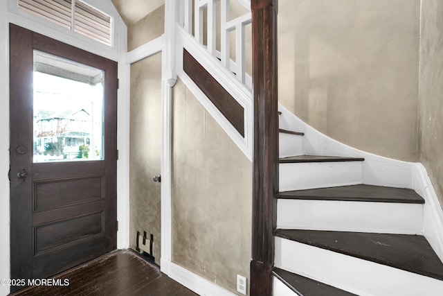 entrance foyer featuring stairway and wood finished floors