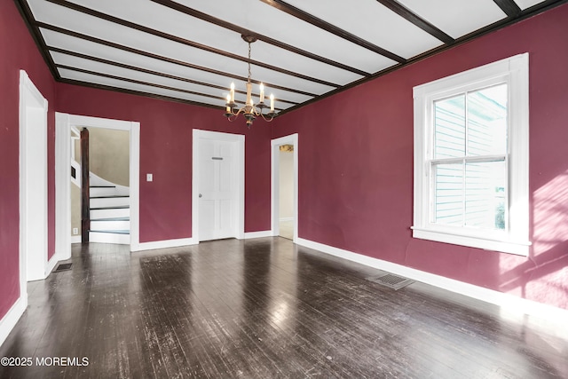 unfurnished dining area featuring a chandelier, stairway, baseboards, and wood finished floors