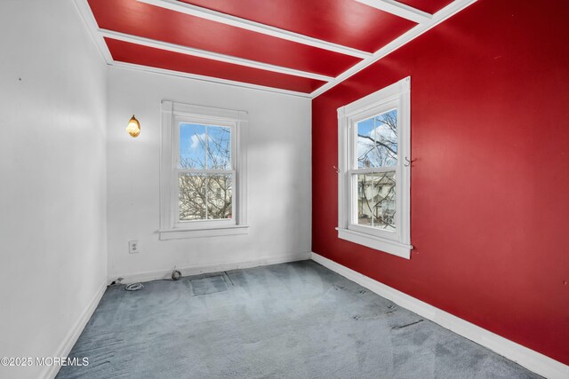 empty room featuring carpet, baseboards, and a wealth of natural light