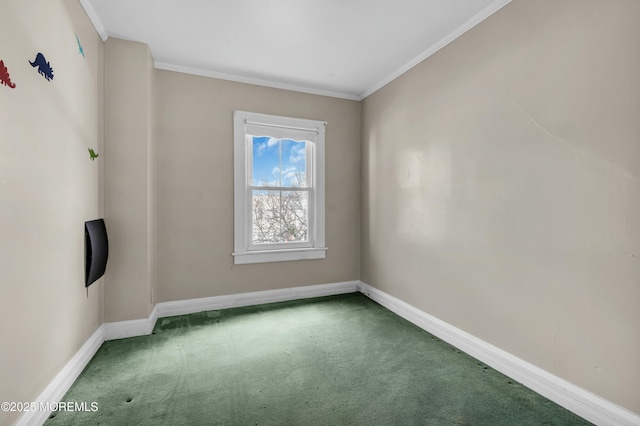 empty room featuring ornamental molding, carpet flooring, and baseboards