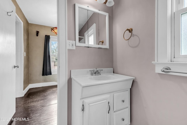 bathroom featuring wood finished floors, vanity, and baseboards