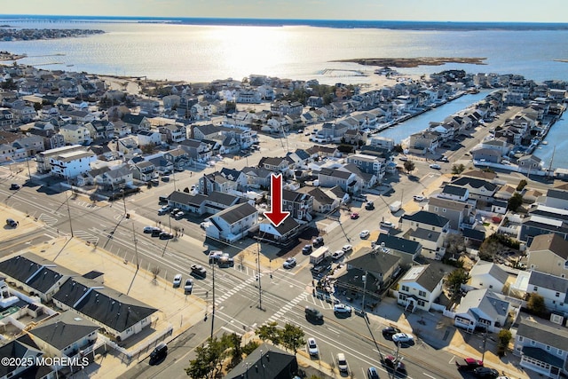 bird's eye view with a water view and a residential view