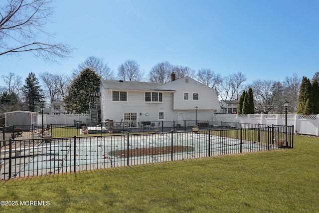 view of pool with a patio area, a lawn, a fenced in pool, and a fenced backyard