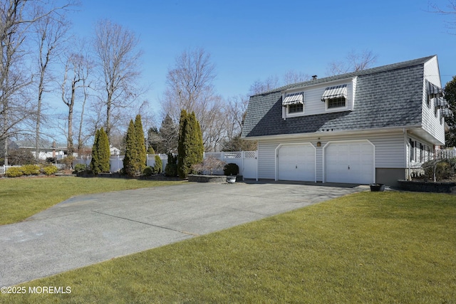 view of property exterior with a detached garage, a yard, fence, and a shingled roof