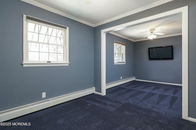 empty room featuring a healthy amount of sunlight, crown molding, and a baseboard radiator