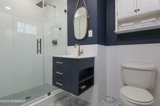 full bath featuring vanity, toilet, tile walls, and a shower stall