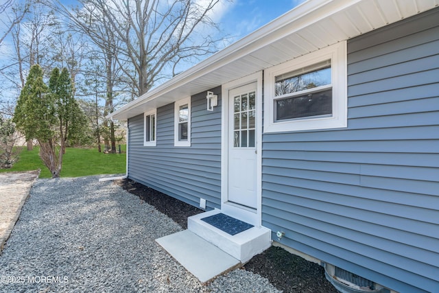 doorway to property featuring a yard