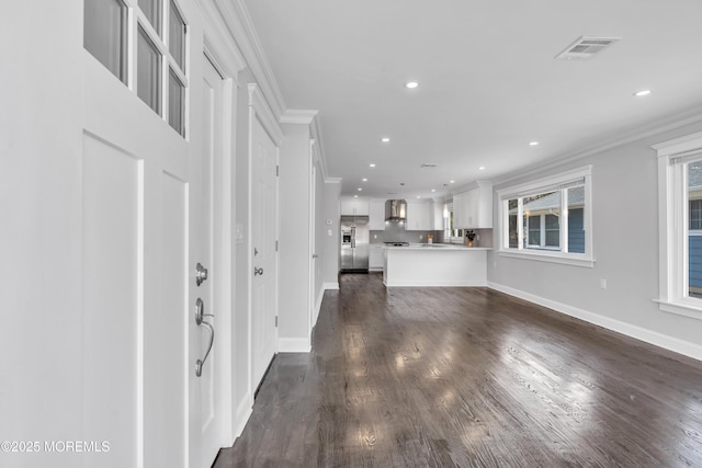 unfurnished living room with visible vents, baseboards, dark wood finished floors, ornamental molding, and recessed lighting