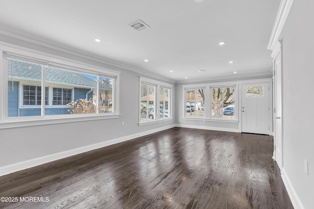 interior space featuring visible vents, dark wood-type flooring, ornamental molding, recessed lighting, and baseboards