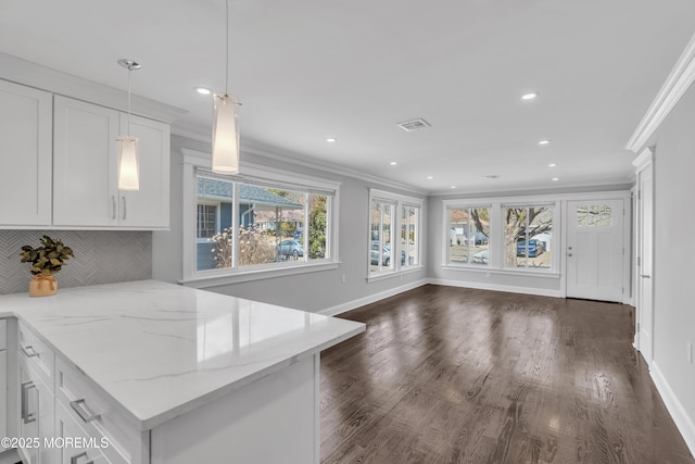 kitchen featuring visible vents, white cabinets, and ornamental molding