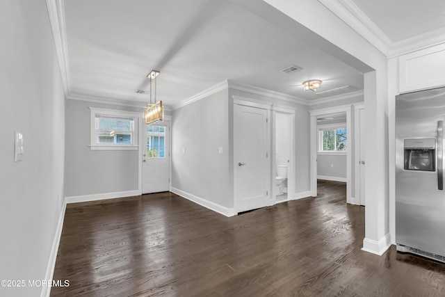 foyer featuring visible vents, baseboards, dark wood-style floors, and crown molding