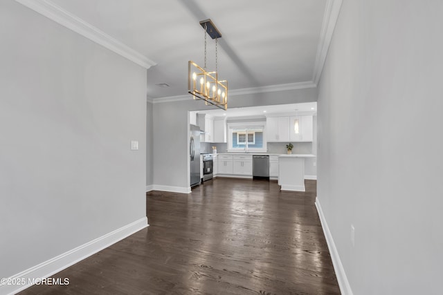 unfurnished living room with dark wood finished floors, crown molding, baseboards, and a chandelier