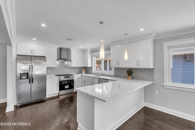 kitchen featuring visible vents, a peninsula, white cabinets, appliances with stainless steel finishes, and wall chimney range hood